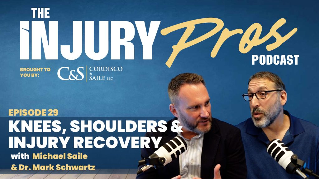 Two men with microphones speak on "The Injury Pros Podcast" episode about knees, shoulders, and injury recovery, featuring Michael Saile and Dr. Mark Schwartz.