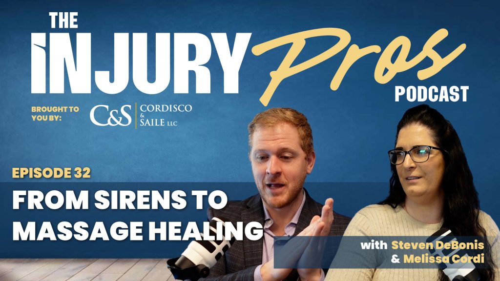 Two podcast hosts, a man and a woman, sit with microphones against a blue background featuring "The Injury Pros Podcast" and episode details about massage healing.